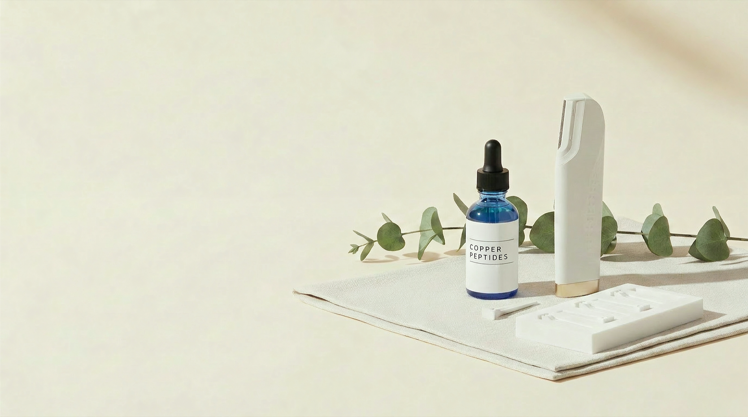 GlowPrep at-home facial system — dermaplaning device, copper peptide serum and blade heads on linen